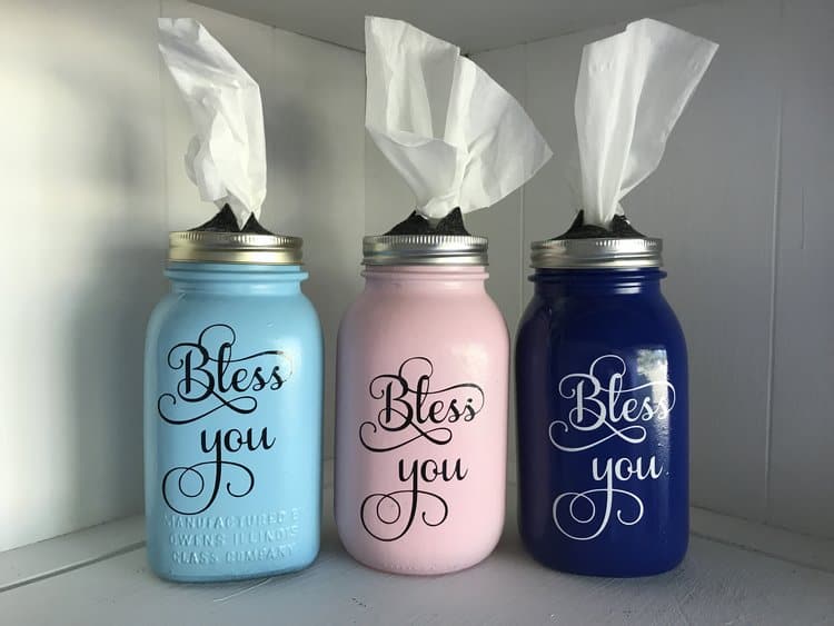 Three DIY mason jar tissue dispensers in blue, pink and dark blue