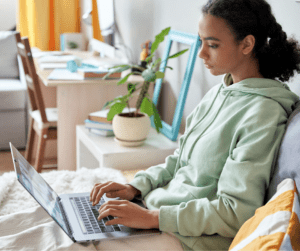 Teen using laptop to find jobs that hire at 15