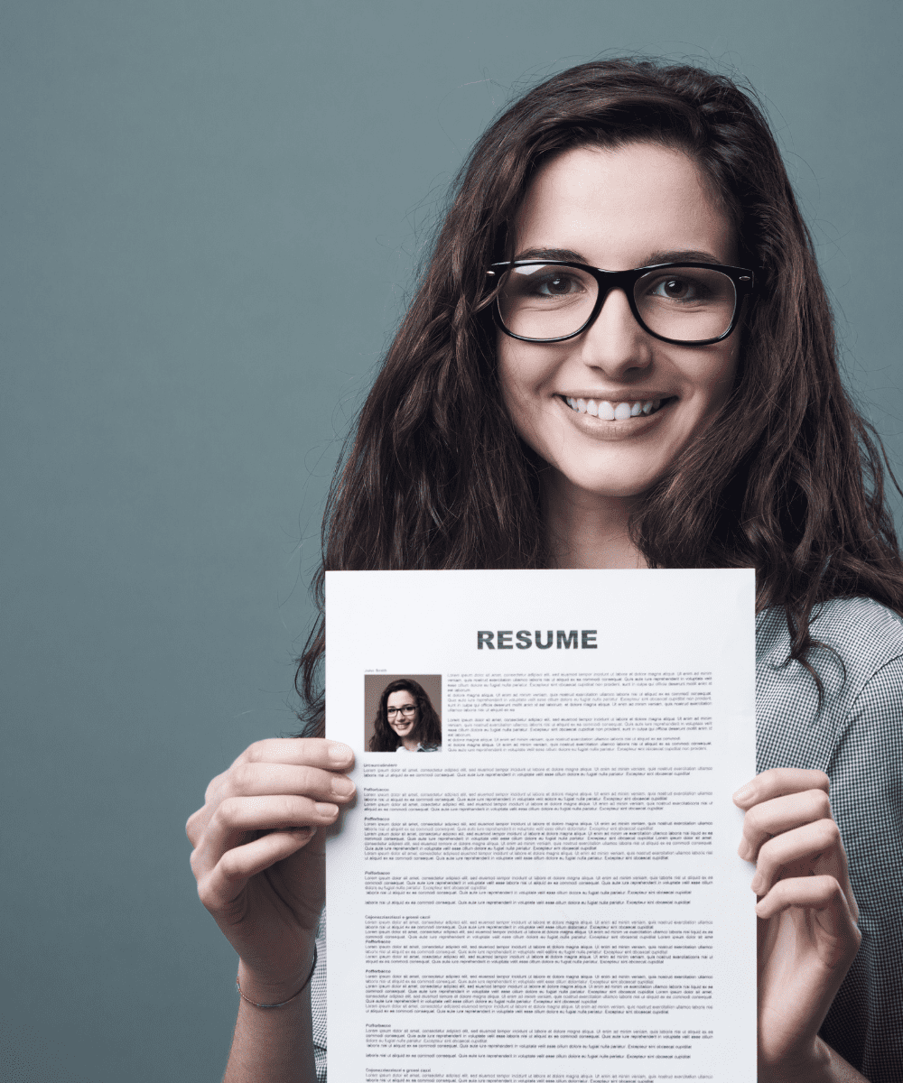 young woman holding a resume to apply for a no fee job.