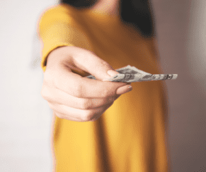 woman holding money - apps that pay instantly to PayPal